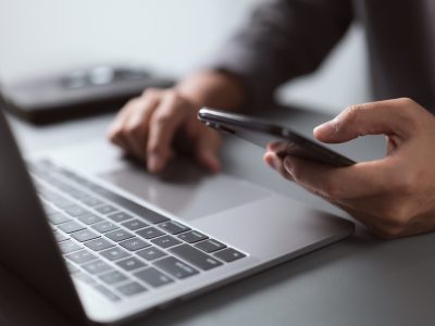 Businessman working with devices. Student using laptop computer Businessman working with devices. Student using laptop computer and mobile smart phone, business concept